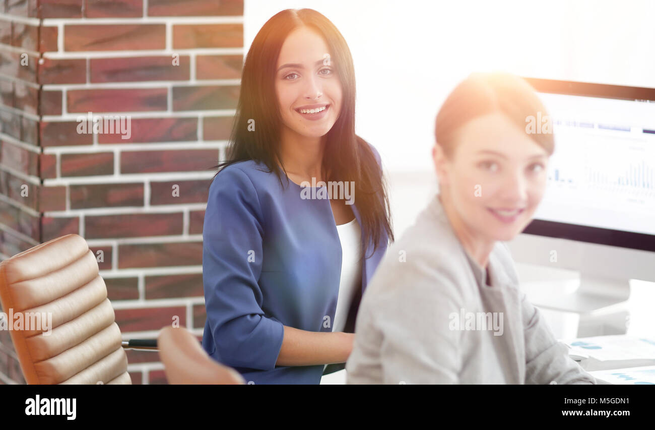 Two young business woman working together in office space Stock Photo ...