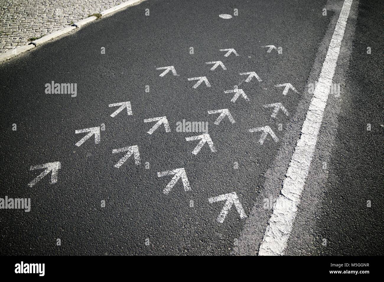 Directional arrows painted on a cement floor Stock Photo - Alamy