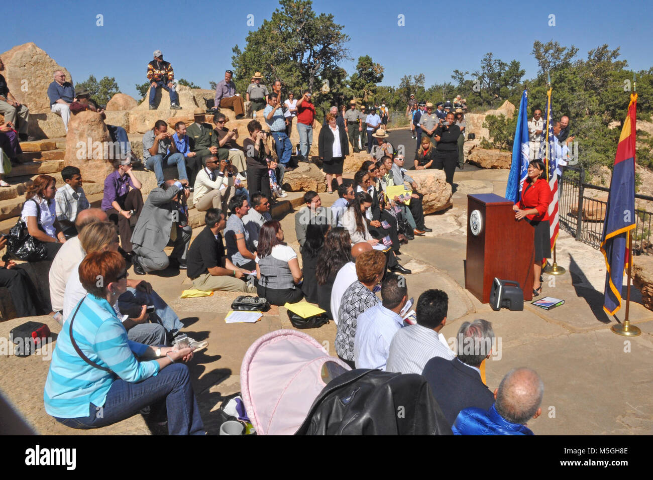 Naturalization Ceremony Grand Canyon mq  On Thursday, September 23, Grand Canyon National Park in coordination with The Department of Homeland Security, hosted a naturalization ceremony at the Mather Amphitheatre on the South Rim. This is the first time in history that Grand Canyon National Park has hosted such an event.   Under blue skies and before a breathtaking view, 23 individuals from 12 different countries including, Colombia, Dominican Republic, Guatemala, Japan, Mexico, Morocco, Australia, Trinidad and Tobago, Uruguay, Venezuela, Vietnam and Zambia, became naturalized citizens. Many f Stock Photo