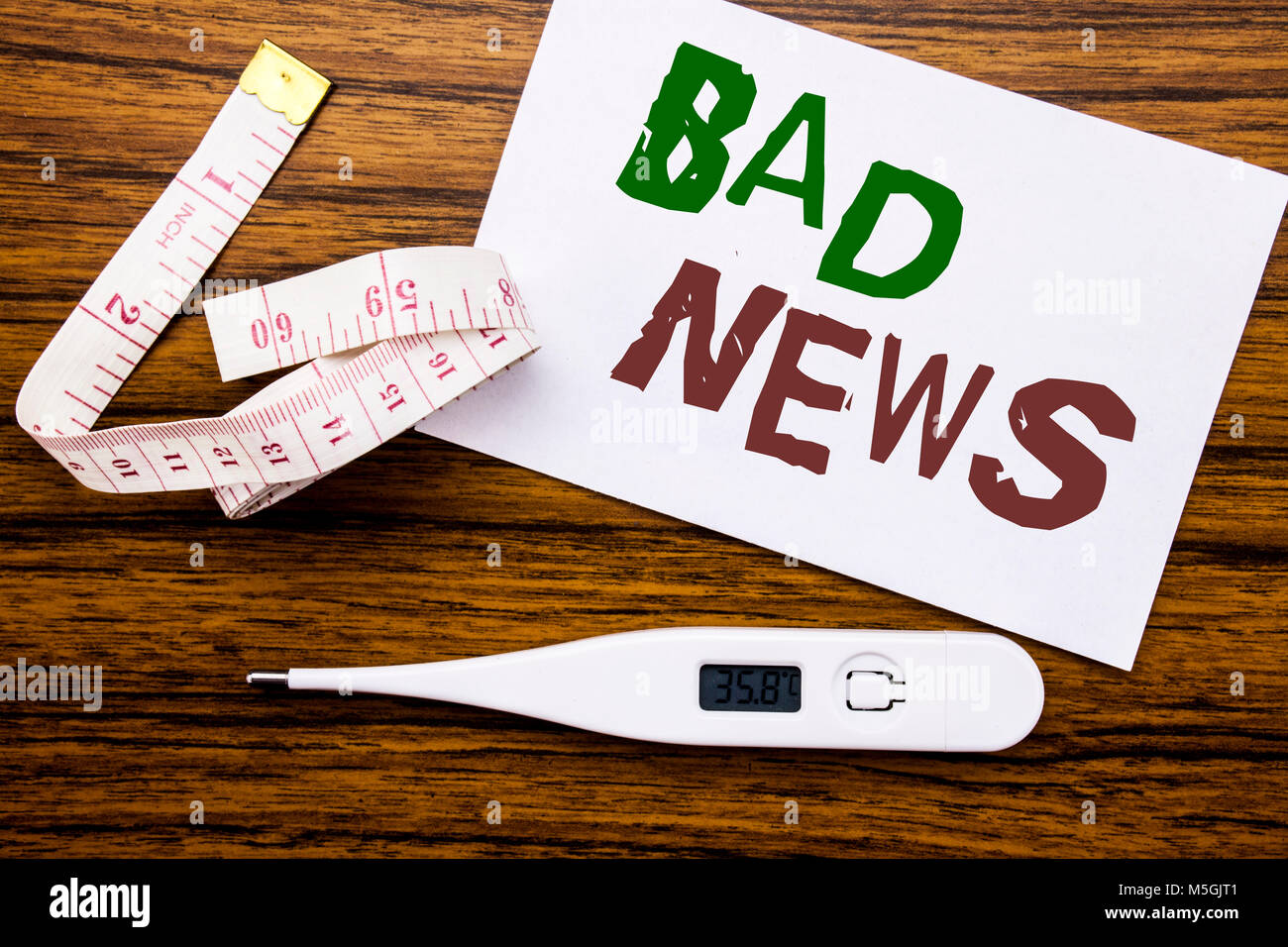 Conceptual hand writing text caption showing Bad News. Business concept for Failure Media Newspaper written on sticky note paper wood background. Mete Stock Photo