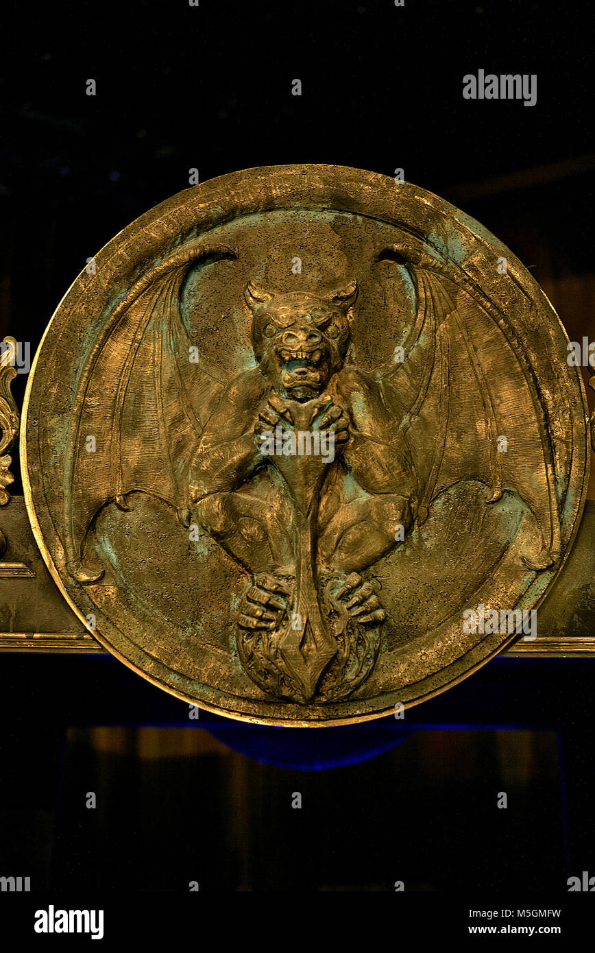Metal plaque engraved with Satanic figure and mythical beast Stock Photo