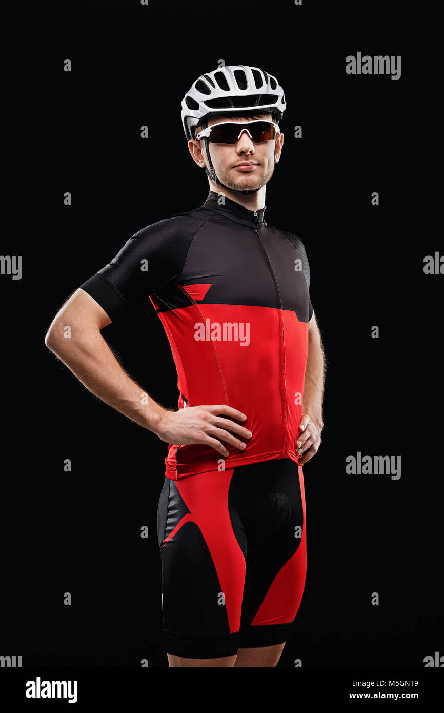 Sport. Cyclist in training clothes on black background. Stock Photo