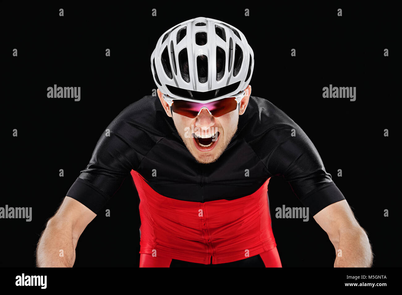 Sport. Cyclist in training clothes on black background. Stock Photo