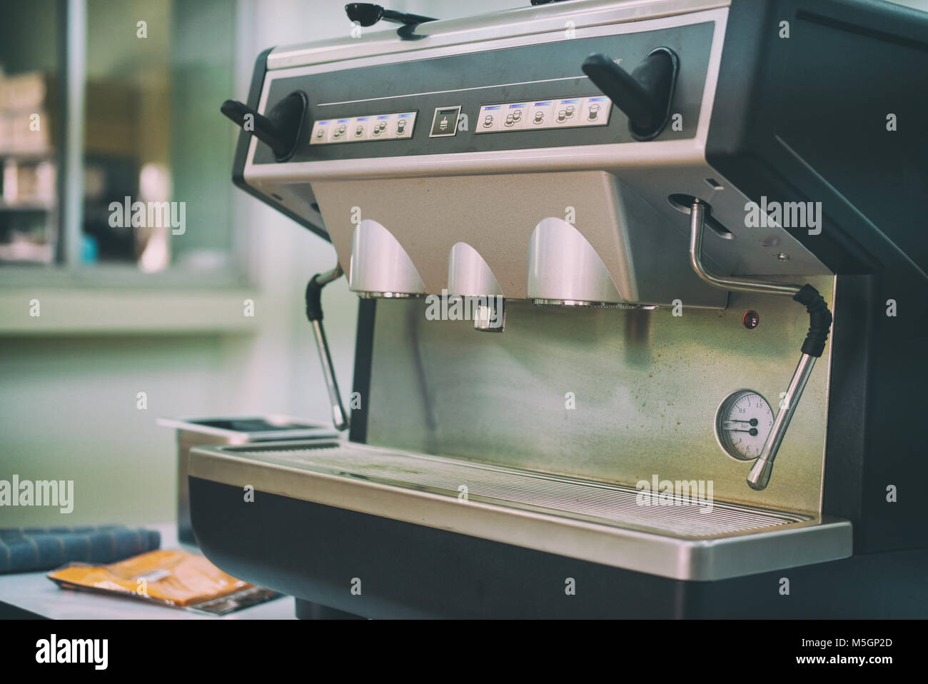 professional coffee machine for brewing espresso on bar counter in cafe
