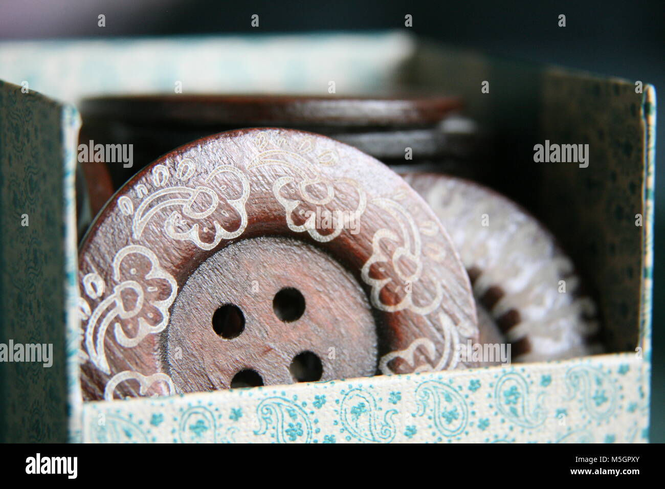 Decorative box filled with large wooden buttons Stock Photo