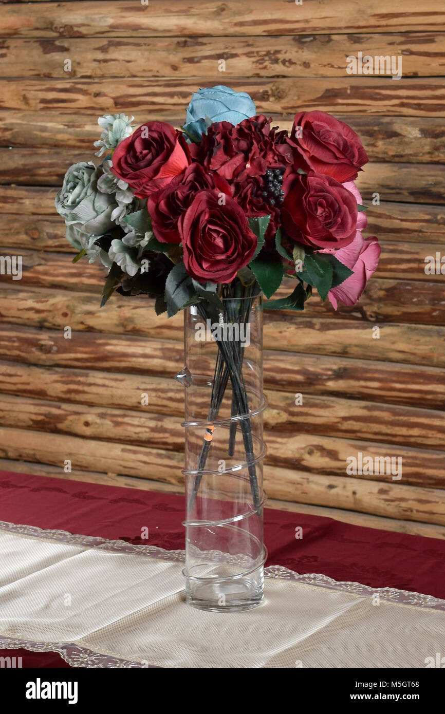 Glass Vase With Artificial Flowers On The Table Stock Photo