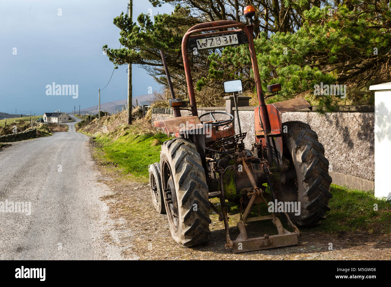 Old Massey Ferguson Tractor on country lane in Ireland Stock Photo