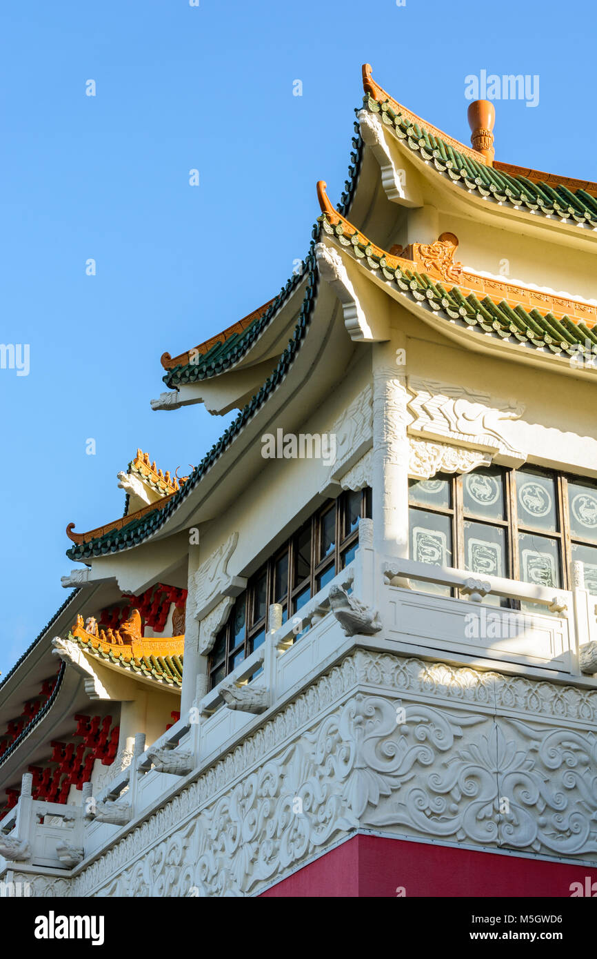 View of the chinese-inspired architecture of the Huatian Chinagora hotel complex with curved roof corners and traditional glazed roof tiles. Stock Photo