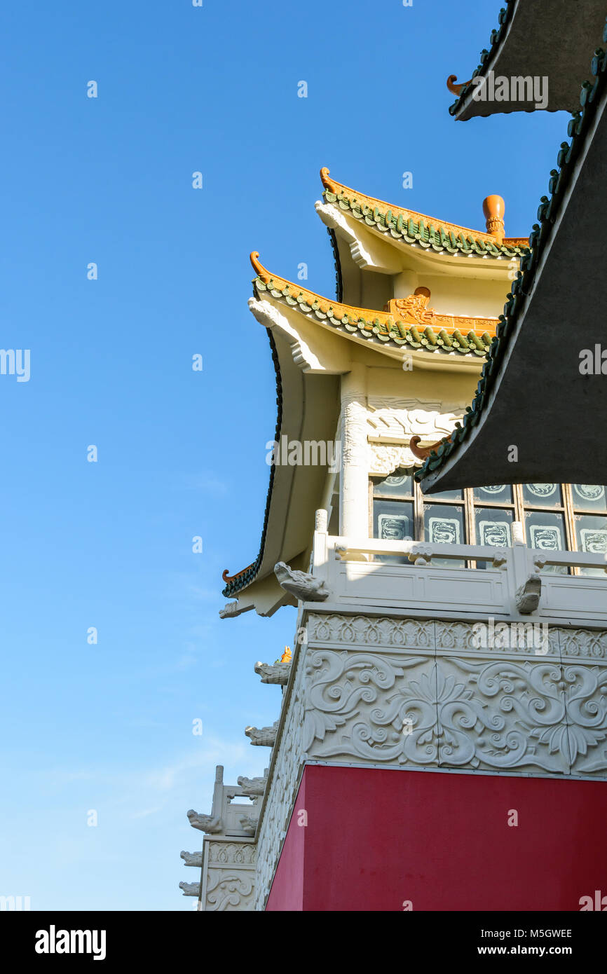 View of the chinese-inspired architecture of the Huatian Chinagora hotel complex with curved roof corners and traditional glazed roof tiles. Stock Photo