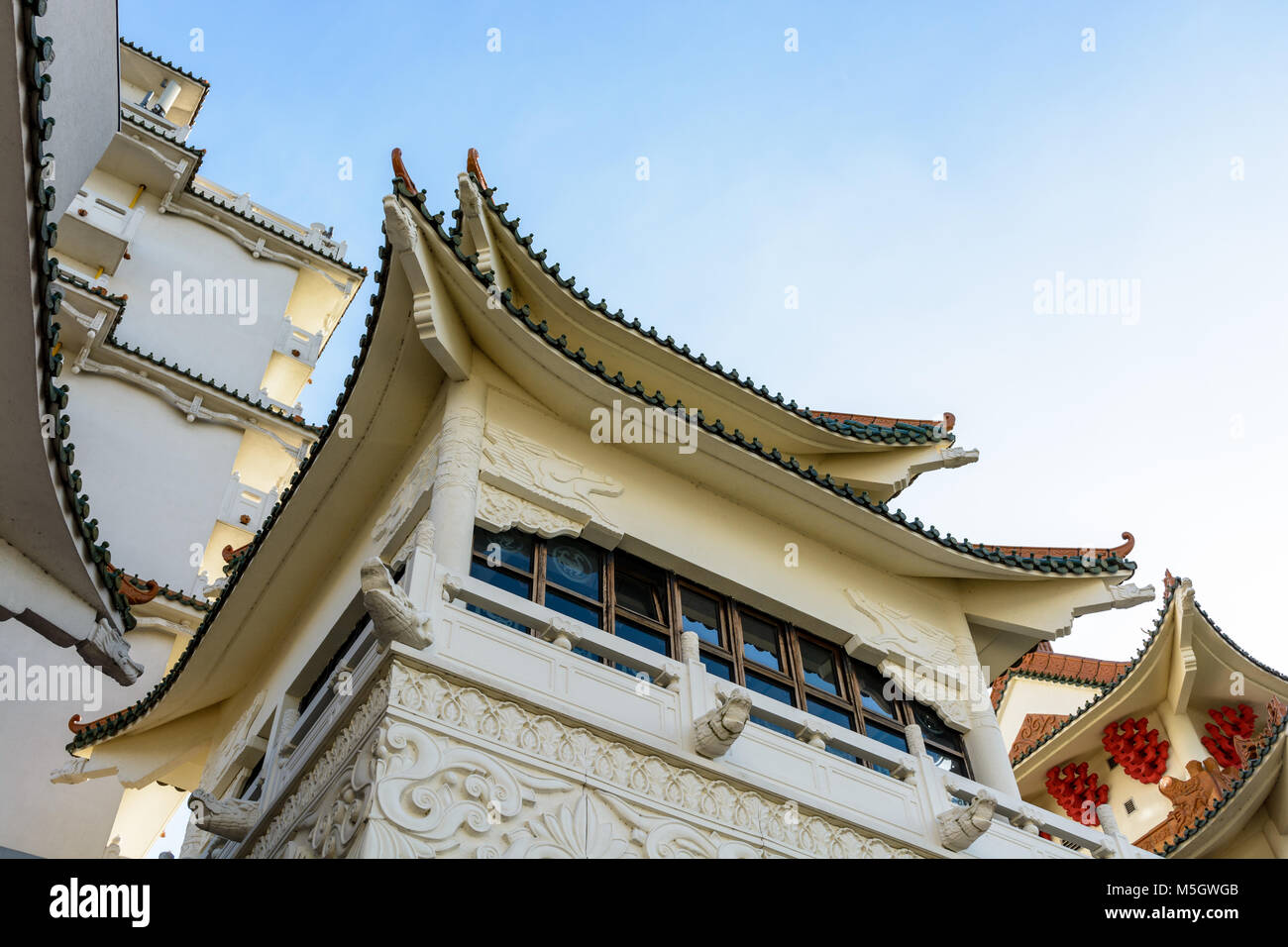 View of the chinese-inspired architecture of the Huatian Chinagora hotel complex with curved roof corners and traditional glazed roof tiles. Stock Photo