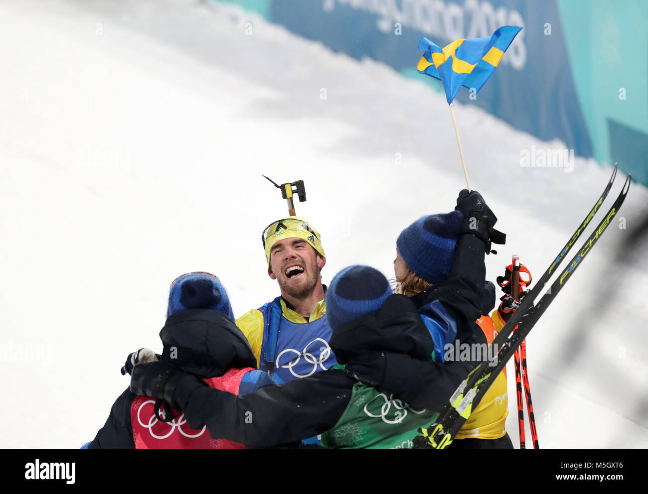 Pyeongchang, South Korea. 23rd Feb, 2018. Fredrik Lindstroem (2nd L) of Sweden celebrates victory with team mates after crossing finishing line of men's 4x7.5km relay of biathlon at the 2018 PyeongChang Winter Olympic Games at Alpensia Biathlon Centre, PyeongChang, South Korea, Feb. 23, 2018. Team Sweden claimed champion in a time of 1:15:16.5. Credit: Li Gang/Xinhua/Alamy Live News Stock Photo