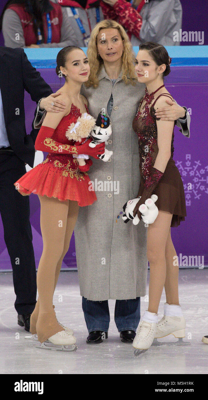 Gangneung, South Korea. 23rd Feb, 2018. Eteri Georgievna Tutberidze, 43, Russian  figure skating coach hugs gold medal winner Alina Zagitova, and silver  medal winner Evgenia Medvedeva of Olympic Athlete from Russia during