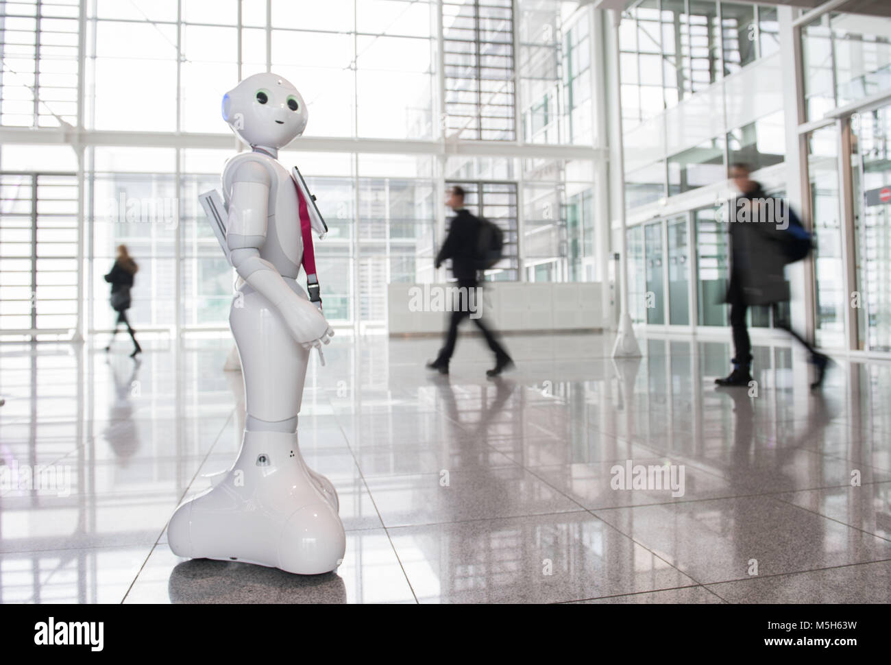 Munich, Germany. 20th Feb, 2018. Robot Josie Pepper assists passengers travelling from the airport in Munich, Germany, 20 February 2018. Pepper is a humanoid robot programmed to analyse and emulate human gestures and facial expressions. Credit: Lino Mirgeler/dpa/Alamy Live News Stock Photo