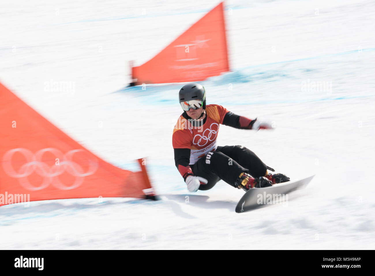 Pyeongchang, South Korea. 24th Feb, 2018. Nevin Galmarini of Switzerland competes during men's parallel giant slalom of snowboard at the 2018 PyeongChang Winter Olympic Games at Phoenix Snow Park, PyeongChang, South Korea, Feb. 24, 2018. Nevin Galmarini won the gold medal in the big final. Credit: Wu Zhuang/Xinhua/Alamy Live News Credit: Xinhua/Alamy Live News Stock Photo
