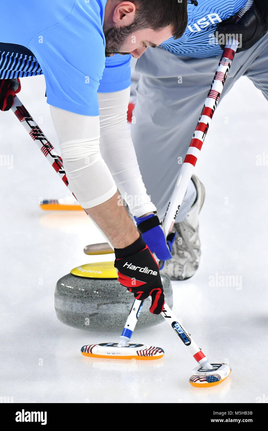 Gangneung, South Korea. 24th Feb, 2018. USA's John Landsteiner (l) and Tyler George in action at the men's curling finals against Sweden at the Curling Centre in Gangneung, South Korea, 24 February 2018. Credit: Peter Kneffel/dpa/Alamy Live News Stock Photo