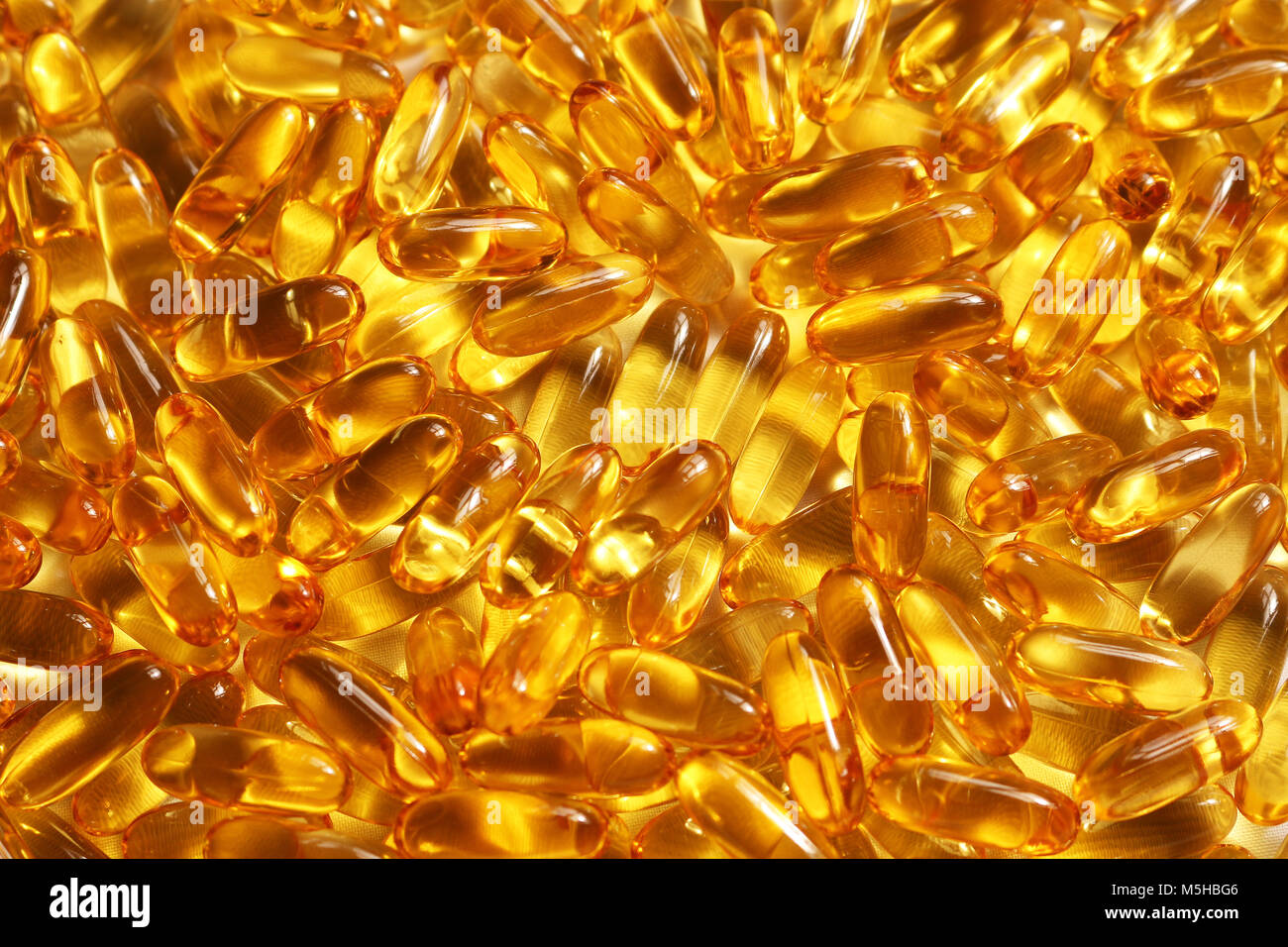 Cod liver oil capsules background texture Stock Photo