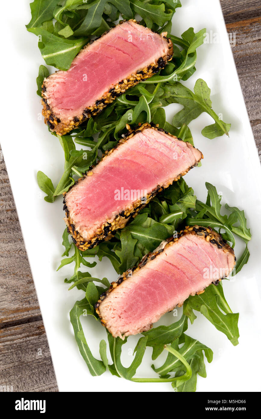tuna tataki sesame crust appetizer plate over wood backgroung Stock