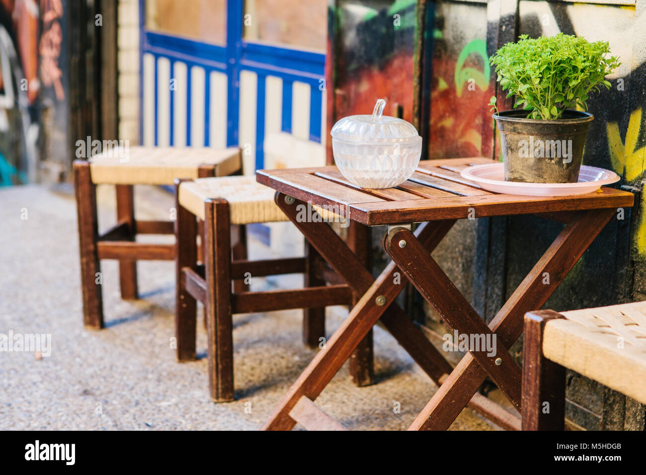 Turkish street cafe in Istanbul. Wooden table and chairs stand directly on the street. A distinctive and authentic place to visit by locals. Morning t Stock Photo