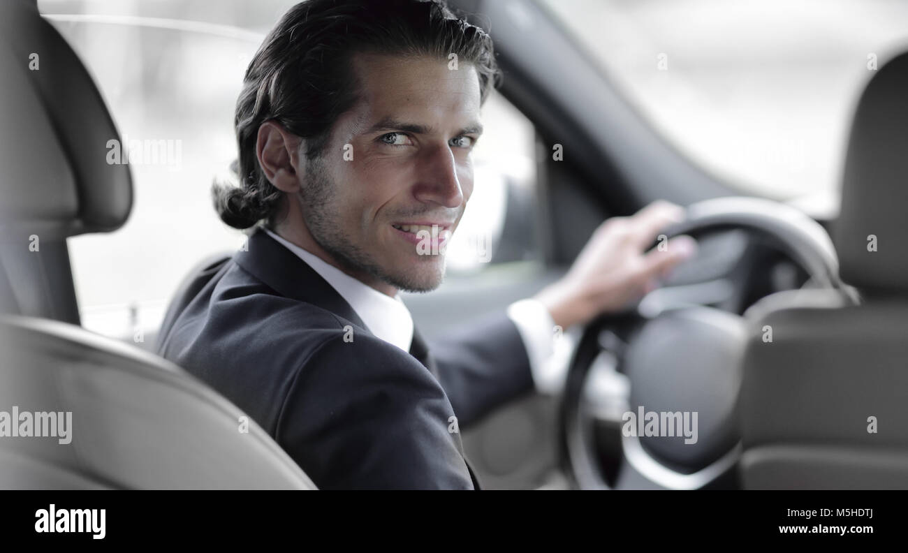 man sitting behind the wheel of a car Stock Photo - Alamy