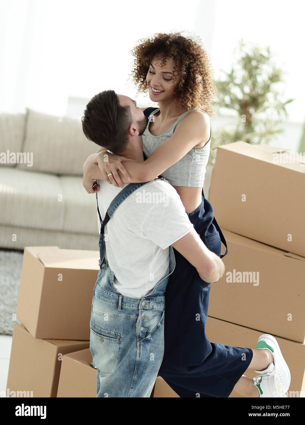 Portrait of a young couple moving into a new home Stock Photo - Alamy