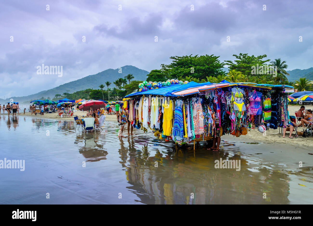 BRAZIL, JUQUEI  -DECEMBER 20th, 2017 ;  Seller on a rainy day on the beach in Juquei, Sao Paulo state, Brazil. Stock Photo