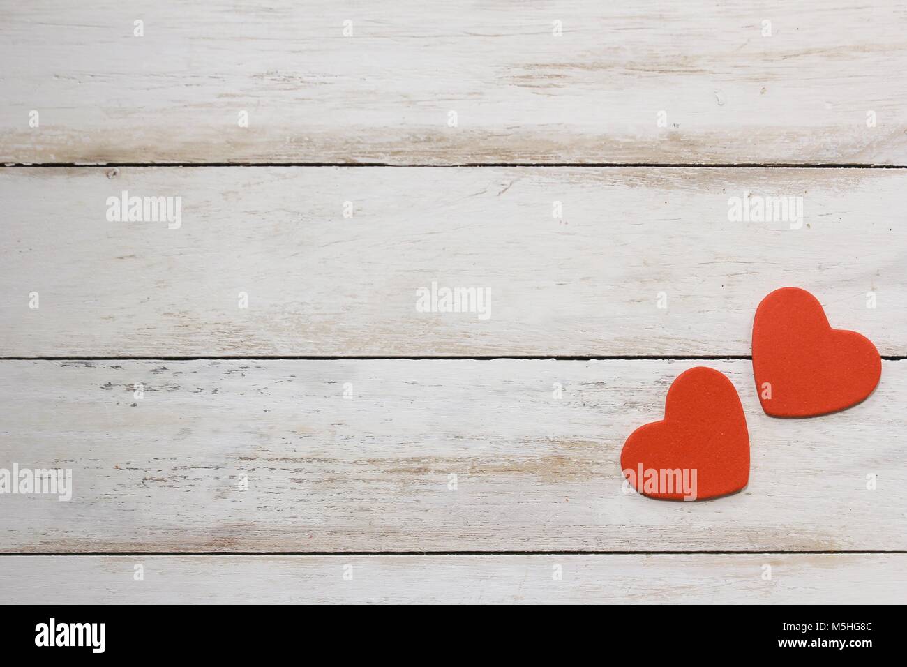 Two red hearts on white wooden background / Valentines day card with ...