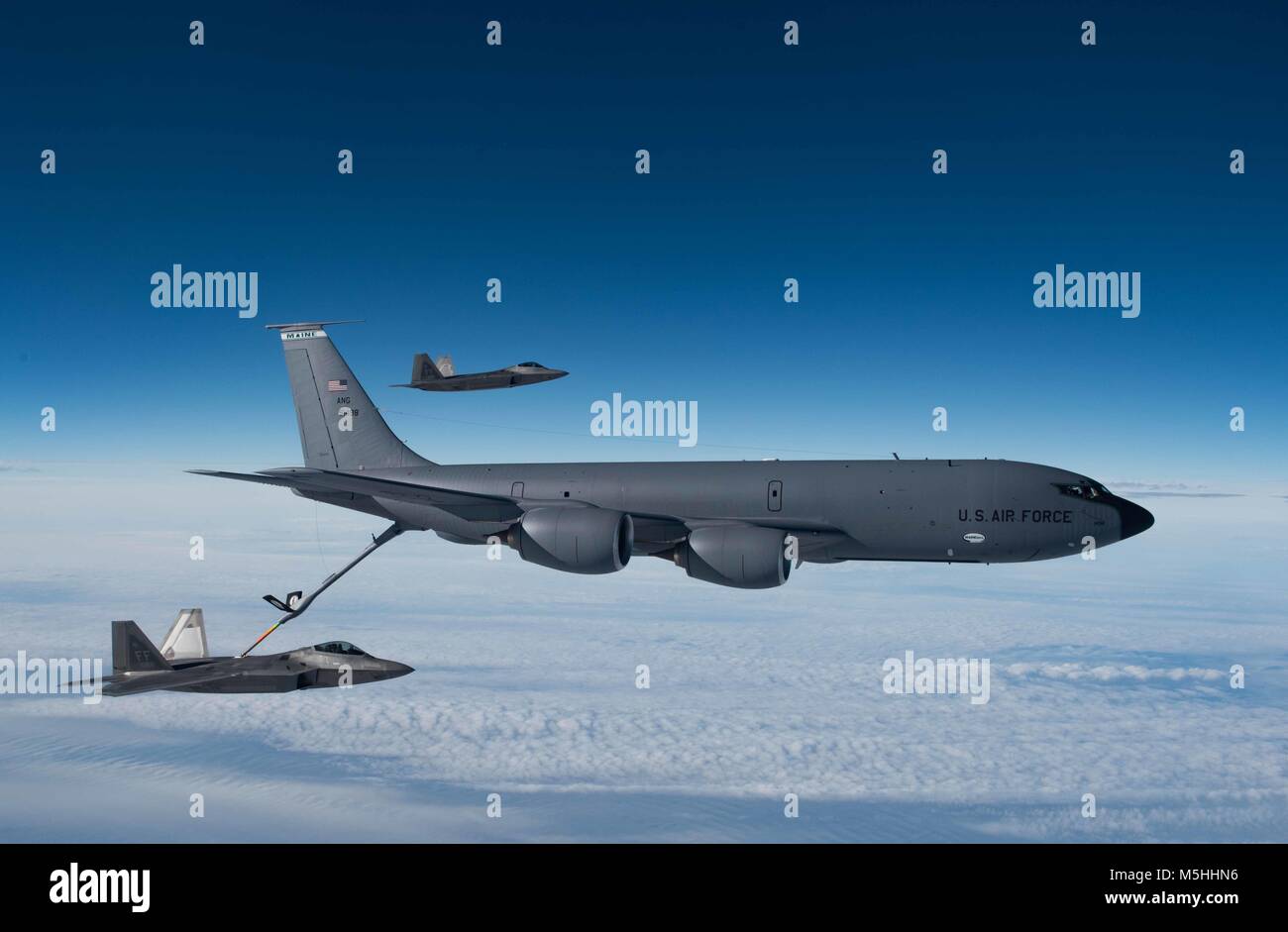 A KC-135 Stratotanker from the 101st Air Refueling Wing refuels F-22 ...