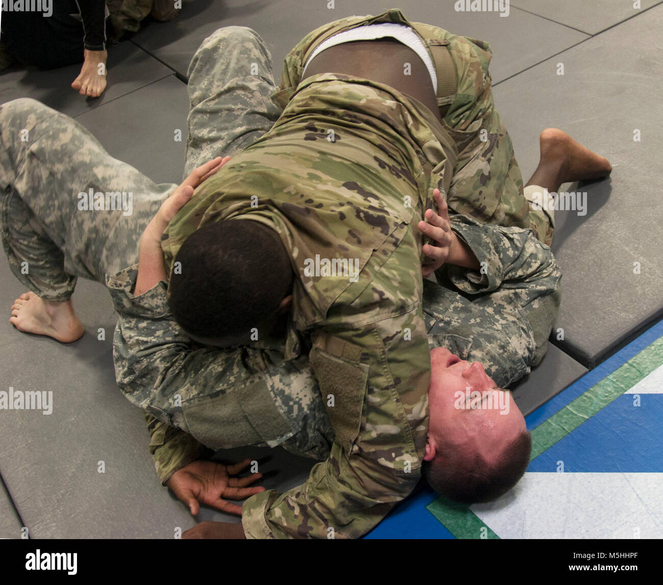 Spc. Reginald Lamb a 3rd Infantry Division combatives team member assigned to Company E, 9th Engineer Battalion, 2nd Armored Brigade Combat Team pins down fellow team member Spc. Ethan Stevens, assigned to Company H., 3rd Battalion, 67th Armor Regiment, 2nd Armored Brigade Combat Team during a chaplain’s inspirational combatives training session, February 13, 2018, at Fort Stewart, Ga. The Fort Stewart combatives team will represent the 3rd Infantry Division in the upcoming Army Combative Championships at Fort Bragg, N.C., February 28 through March 3. (U.S. Army Stock Photo