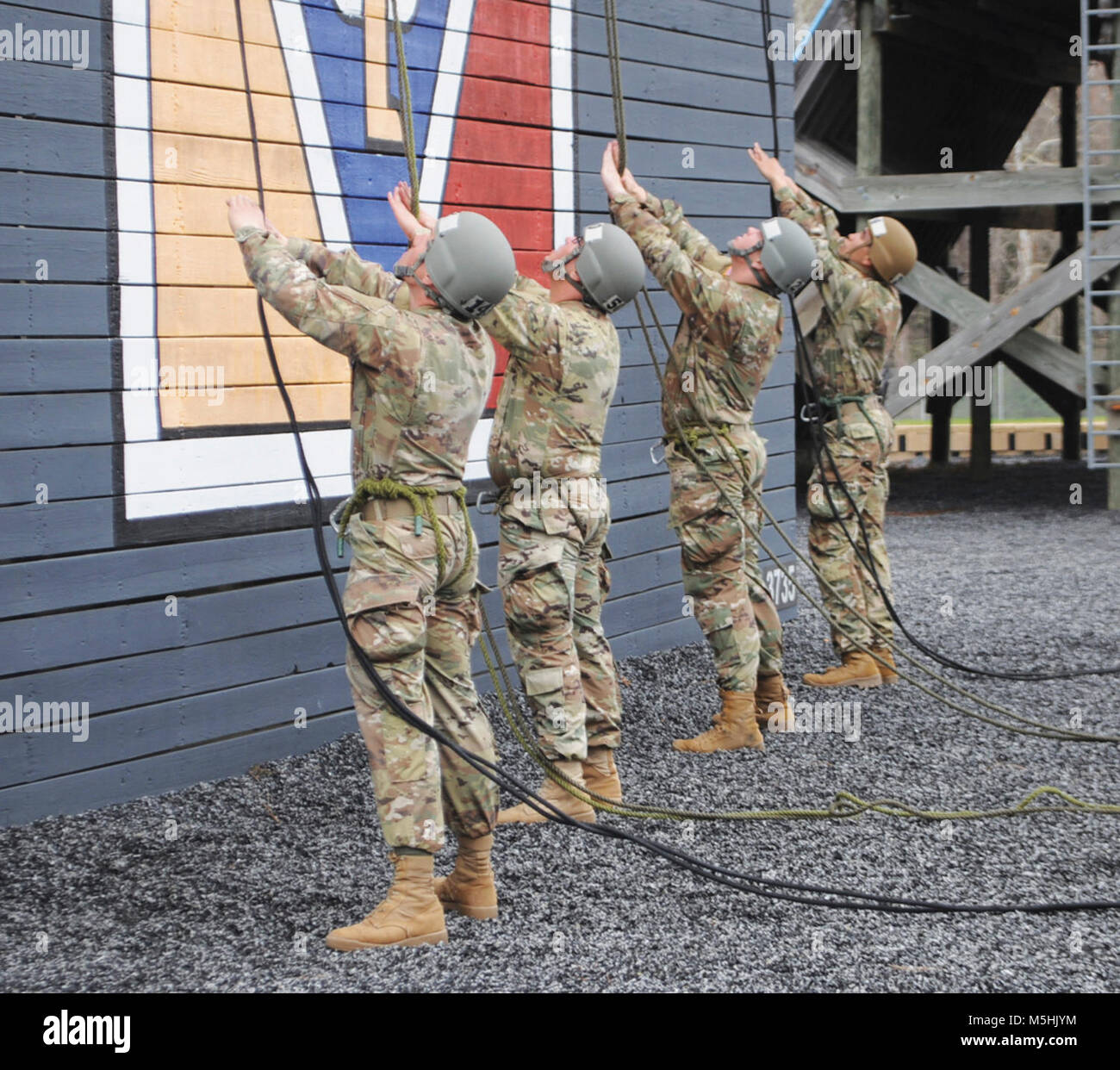 Line handlers on the ground keep a close eye on their counterparts as ...