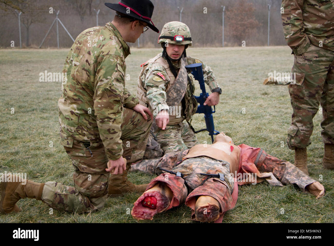 A Georgian soldier from 11th Light Infantry Battalion, 1st Infantry Brigade, Georgian Land Forces, explains how he is treating a simulated casualty to Spc. Wesley Hobson, a combat medic assigned to 4th Squadron, 2d Cavalry Regiment,   during a Combat Life Saver course Feb. 9, 2018 at the Medical Simulation Training Center in Grafenwoehr Training Area, Germany. The soldiers are training with U.S. Marine Corpsmen for an upcoming deployment to Afghanistan. The soldiers instructing the course are from 2nd Cavalry Regiment and 7th Army Training Command.  ( Stock Photo