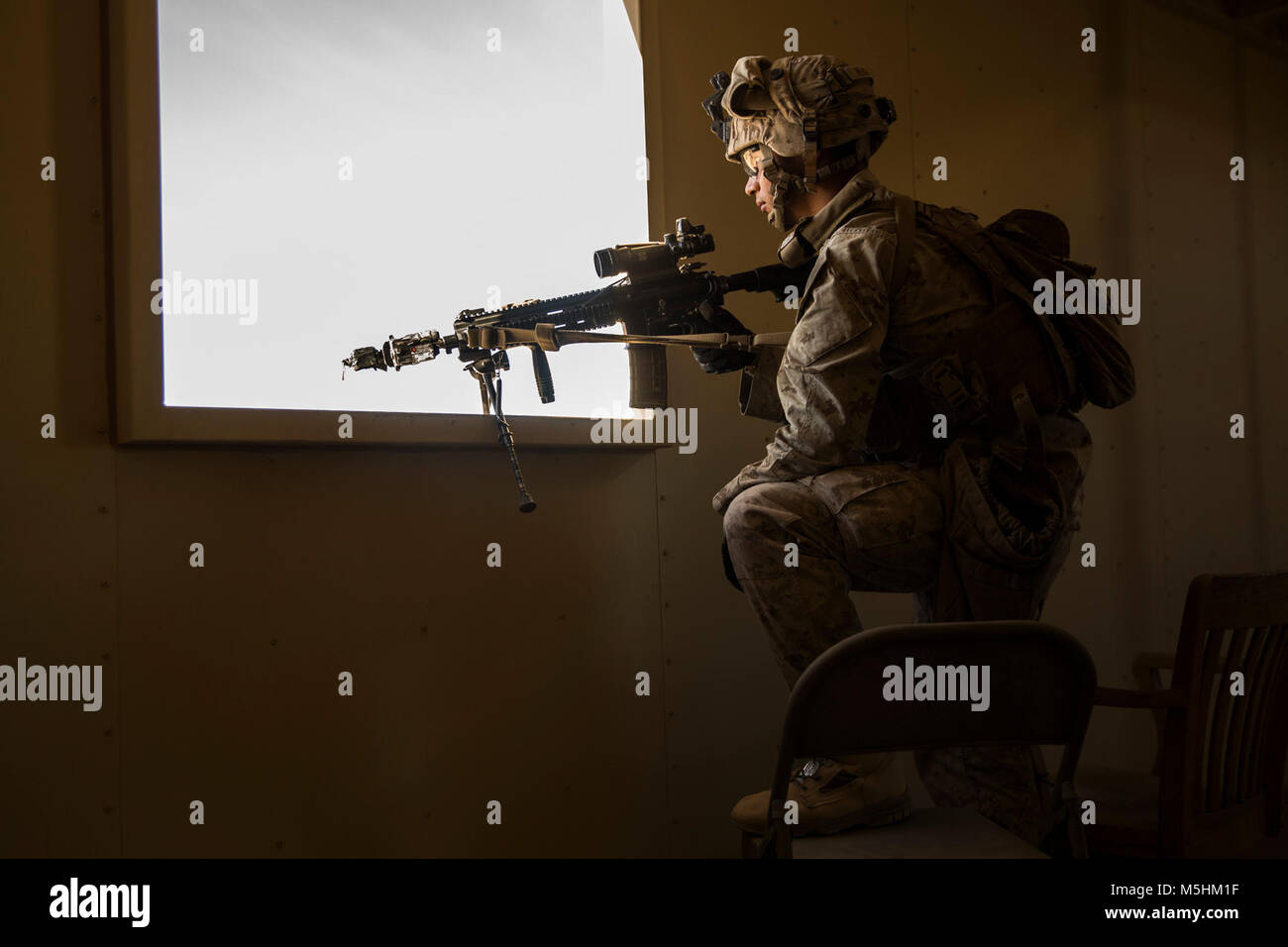 A Marine with 3rd Battalion, 7th Marine Regiment, posts security through a building window at Range 220 aboard the Marine Corps Air Ground Combat Center, Twentynine Palms Calif., Feb. 9, 2018 as part of Integrated Training Exercise 2-18. The purpose of ITX is to create a challenging, realistic training environment that produces combat-ready forces capable of operating as an integrated MAGTF. (U.S. Marine Corps Stock Photo