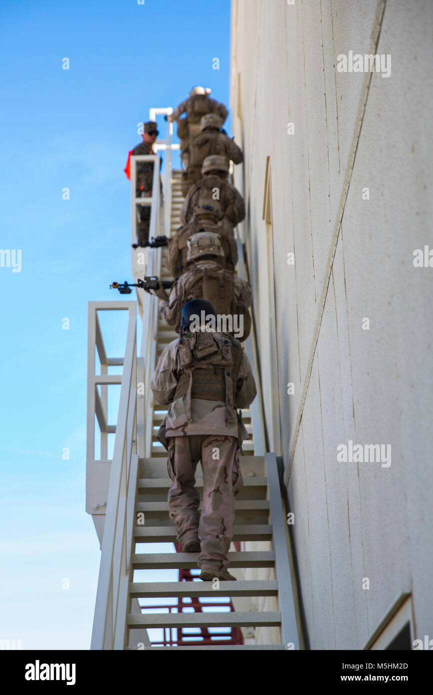 Marines with 3rd Battalion, 7th Marine Regiment, climb to the top of a building at Range 220 aboard the Marine Corps Air Ground Combat Center Twentynine Palms, Calif.,  Feb. 9, 2018 as part of Integrated Training Exercise 2-18. The purpose of ITX is to create a challenging, realistic training environment that produces combat-ready forces capable of operating as an integrated MAGTF. (U.S. Marine Corps Stock Photo