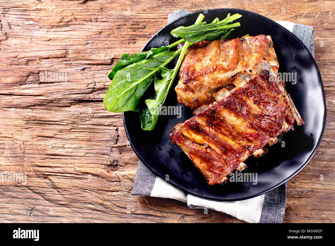Barbecue spare ribs on an rustic wooden table Stock Photo - Alamy