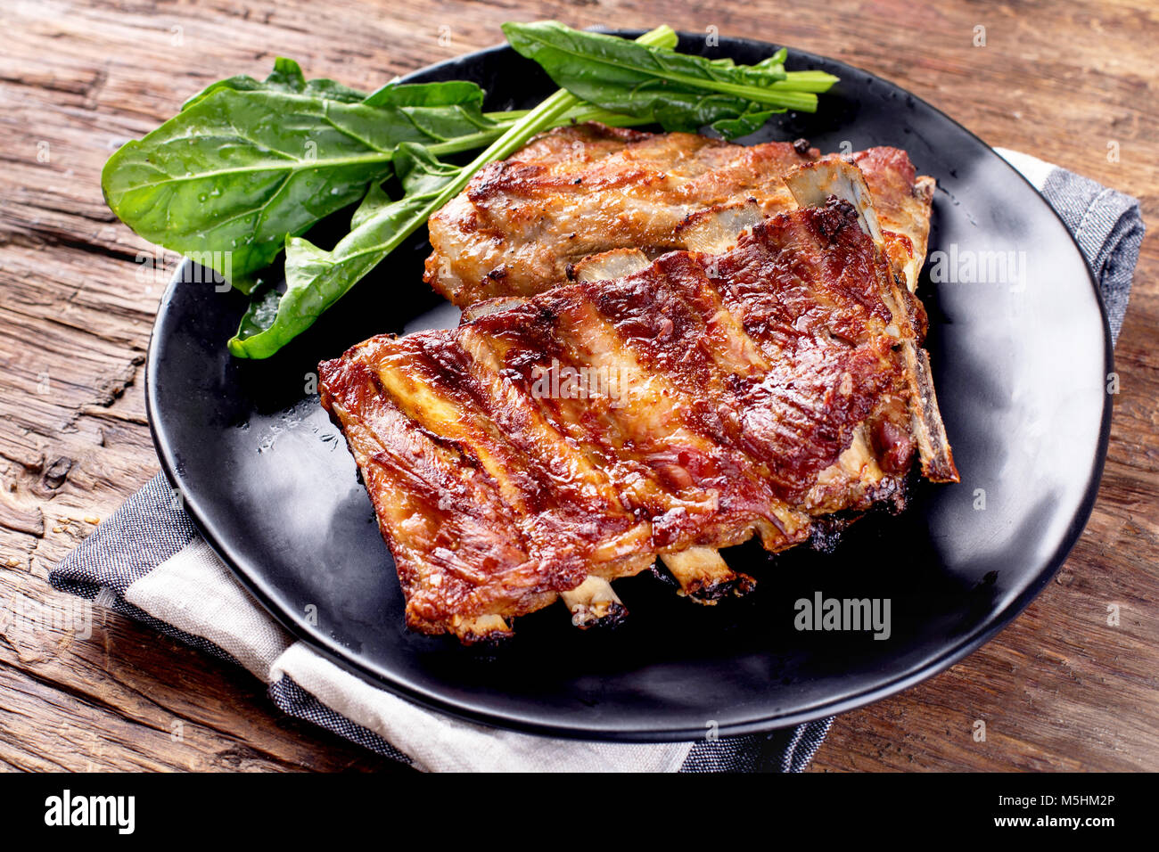 Barbecue spare ribs on an rustic wooden table Stock Photo - Alamy