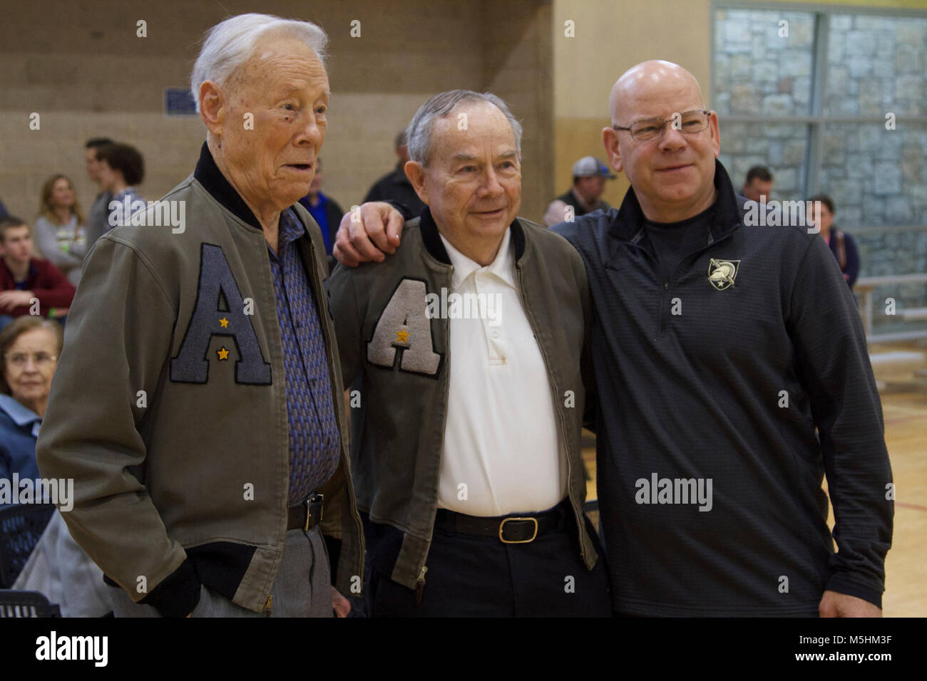 Army West Point Alumni pose with the head coach before the event starts ...