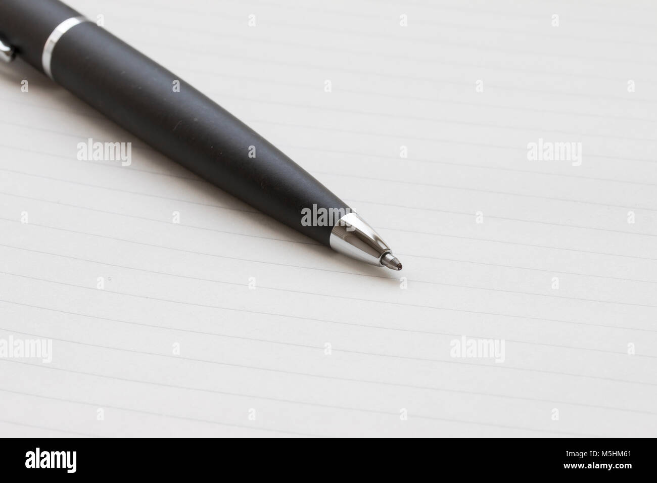 black ballpoint pen nib,on a white notebook background Stock Photo Alamy