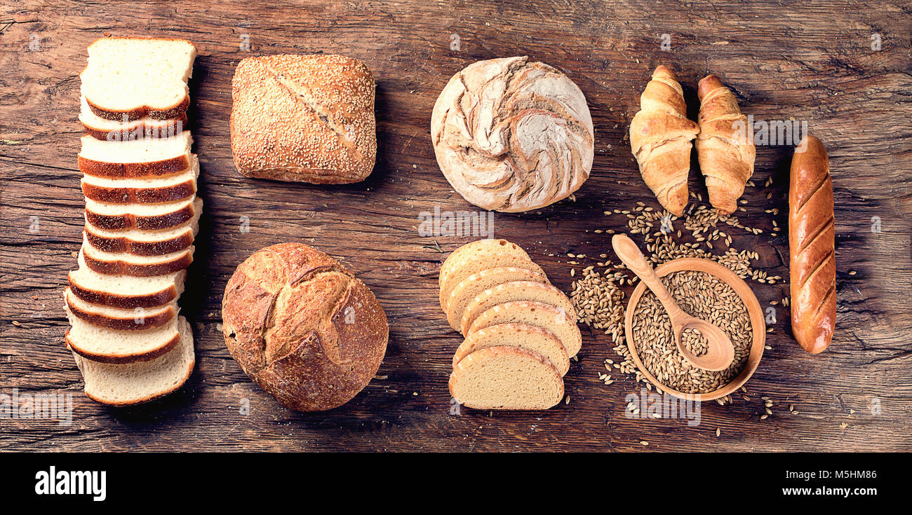 Fresh baked bread on rustic wooden background Stock Photo - Alamy