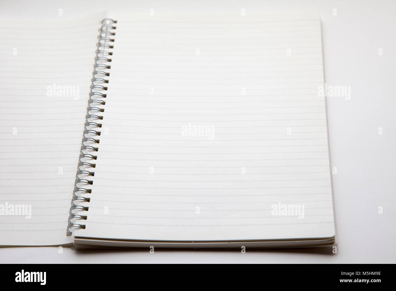 blank open spiral notebook isolated on white background,selective ...