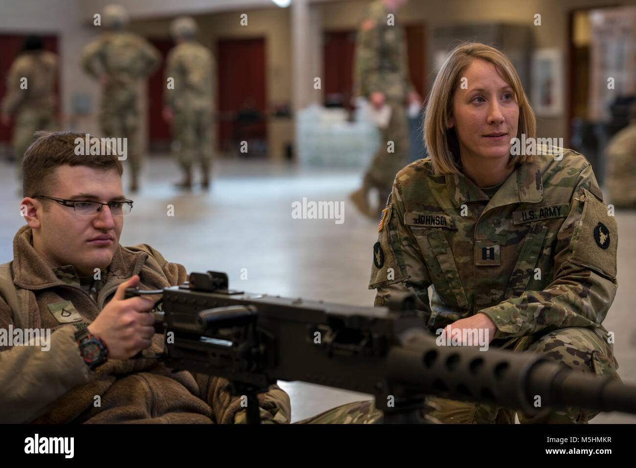 Pfc. Bryan Christenson, a petroleum supply specialist with A Co., 134th Brigade Support Battalion, demonstrates how to operate the M2 .50-caliber machine gun during weapons training to Capt. Janelle Johnson, commander of A Co., 134th BSB, on Feb. 11, 2018, in Arden Hills, Minn. A unique quality about Johnson is that she can relate to Soldiers at every level because she has trained as an enlisted Soldier and a warrent officer before becoming a commissioned officer. (Minnesota National Guard Stock Photo