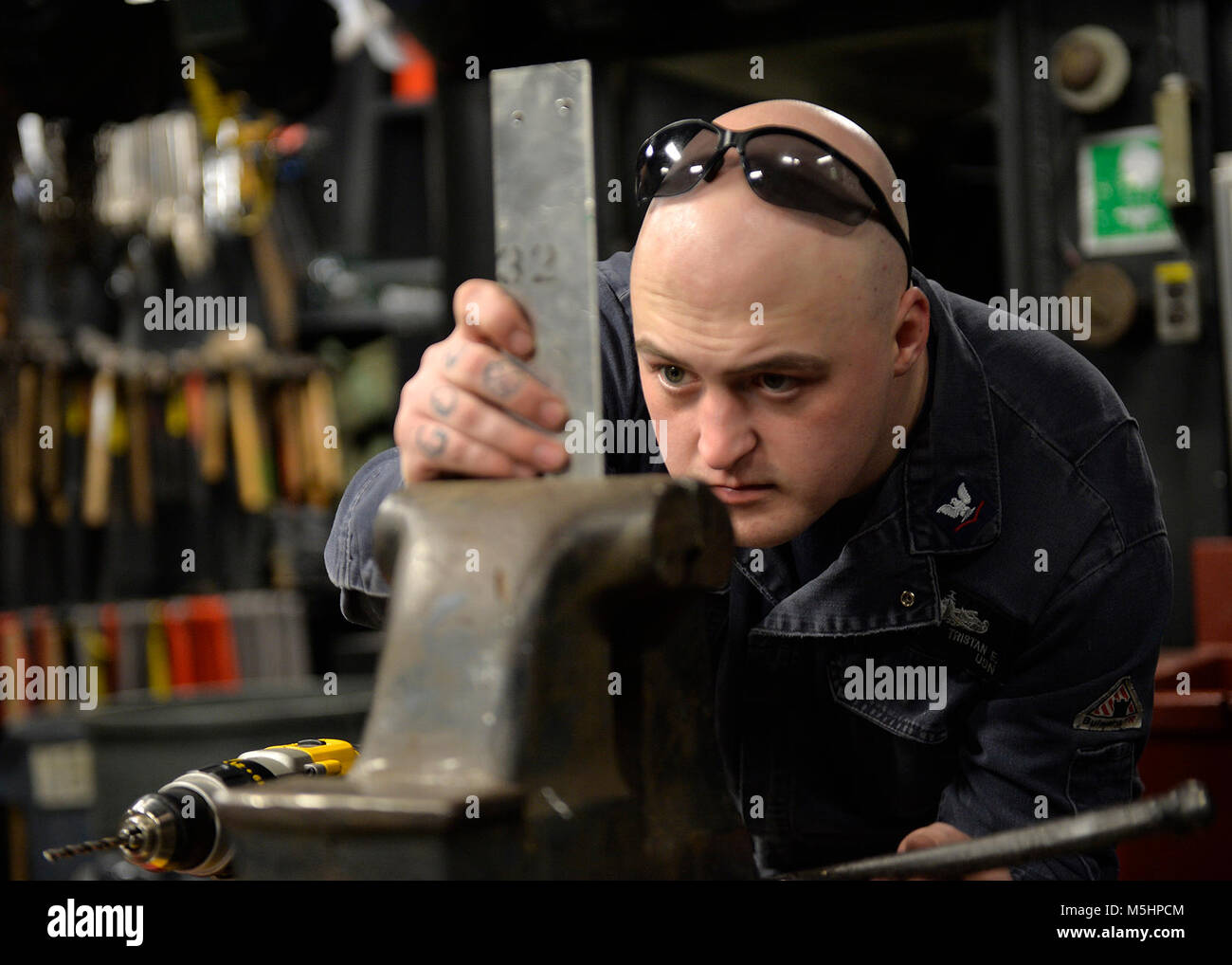 YOKOSUKA, Japan (Feb. 12, 2018) - Hull Maintenance Technician 3rd Class Tristan E. Daugherty, assigned to the U.S. 7th Fleet flagship USS Blue Ridge (LCC 19), constructs brackets to secure for sea. Blue Ridge is in an extensive maintenance period in order to modernize the ship to continue to serve as a robust communications platform in the U.S. 7th Fleet area of operations. (U.S. Navy Stock Photo