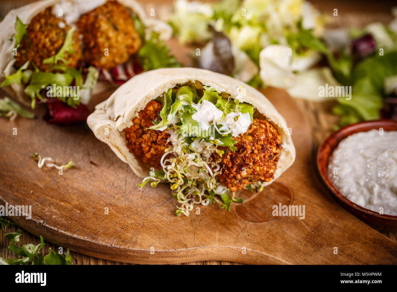 Fresh made falafel sandwich with sprout and tahini sauce Stock Photo