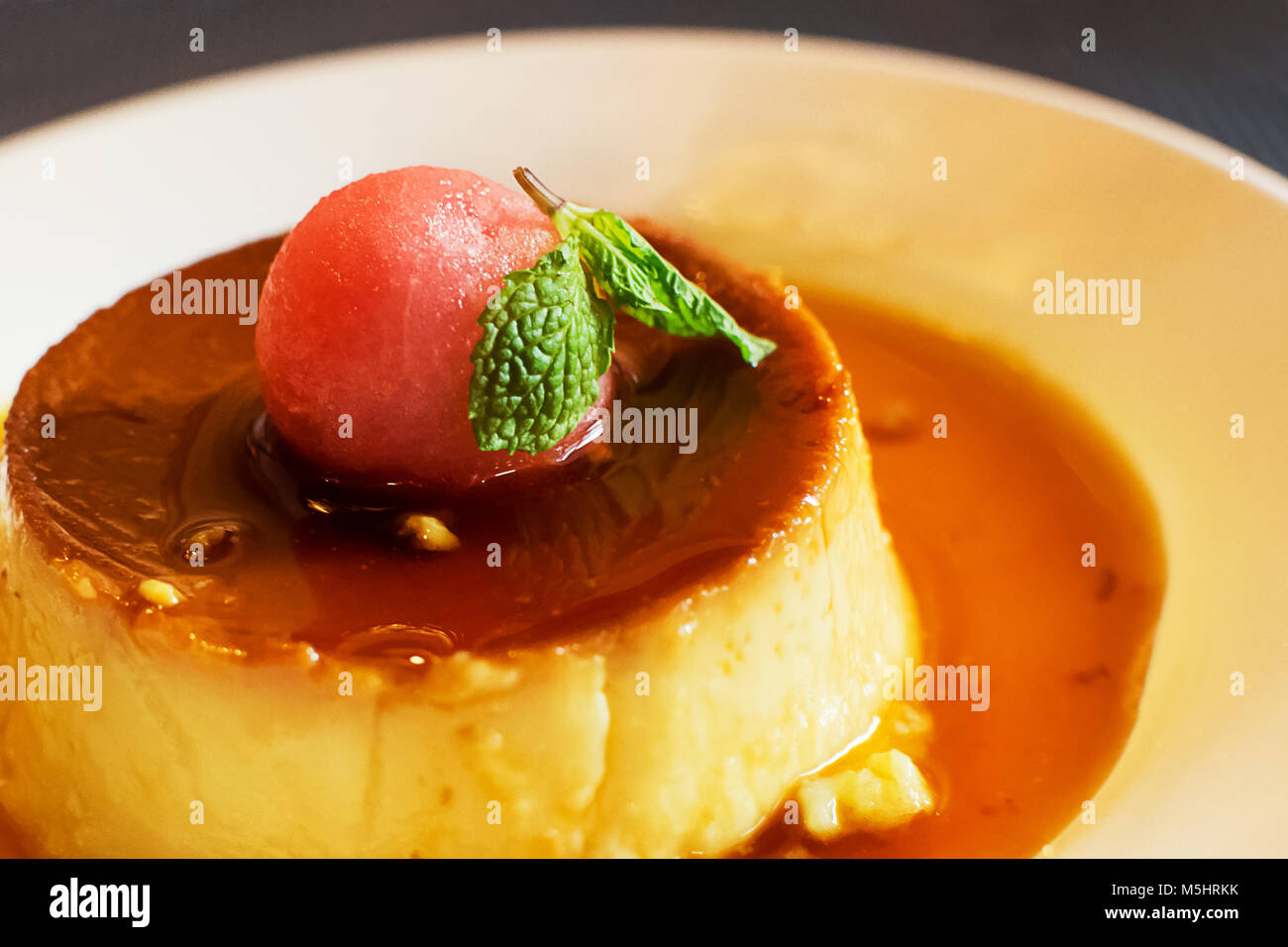 Flan de leche with watermelon ball Stock Photo