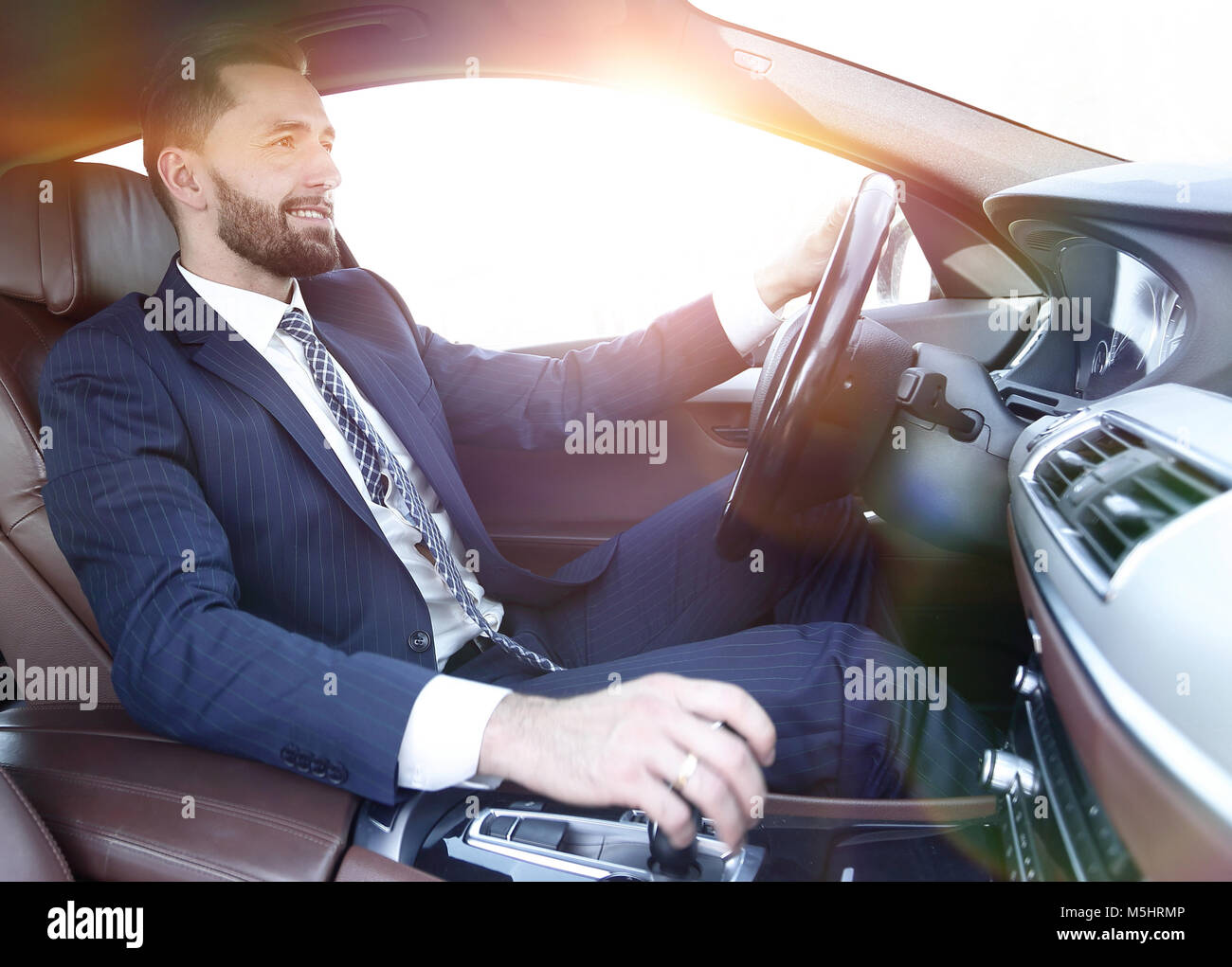 businessman sitting behind the wheel of a car Stock Photo - Alamy