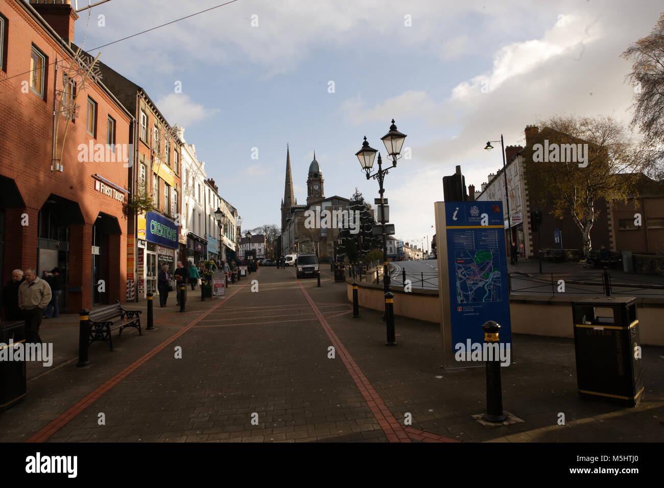 Lisburn, Northern Ireland. Lisburn (/'l?z.b?rn/ or /'l?s.b?rn/; meaning 'fort of the stream', probably from Irish lios, meaning 'fort', and Scots burn, meaning 'stream') is a city in Northern Ireland. It is 8 mi (13 km) southwest of Belfast city centre, on the River Lagan, which forms the boundary between County Antrim and County Down. Lisburn is part of the Belfast Metropolitan Area. It had a population of over 71,469 people in the 2011 Census. Formerly a borough, Lisburn was granted city status in 2002 as part of Queen Elizabeth II's Golden jubilee celebrations. It is the third-largest city  Stock Photo