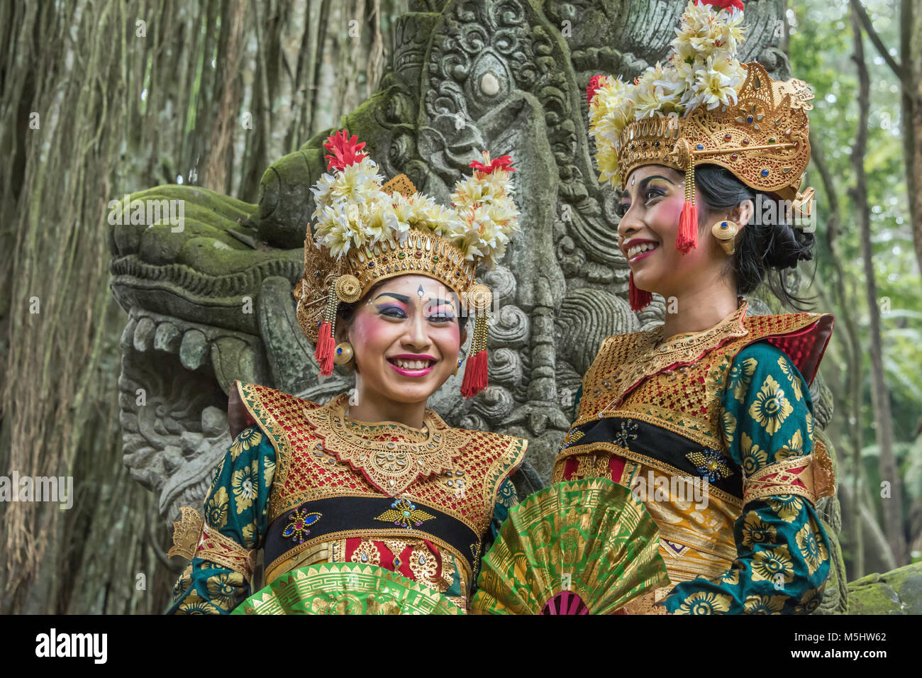 Two smiling dancers in traditional attire, Sacred Monkey Forest Sanctuary, Ubud, Bali, Indonesia Stock Photo