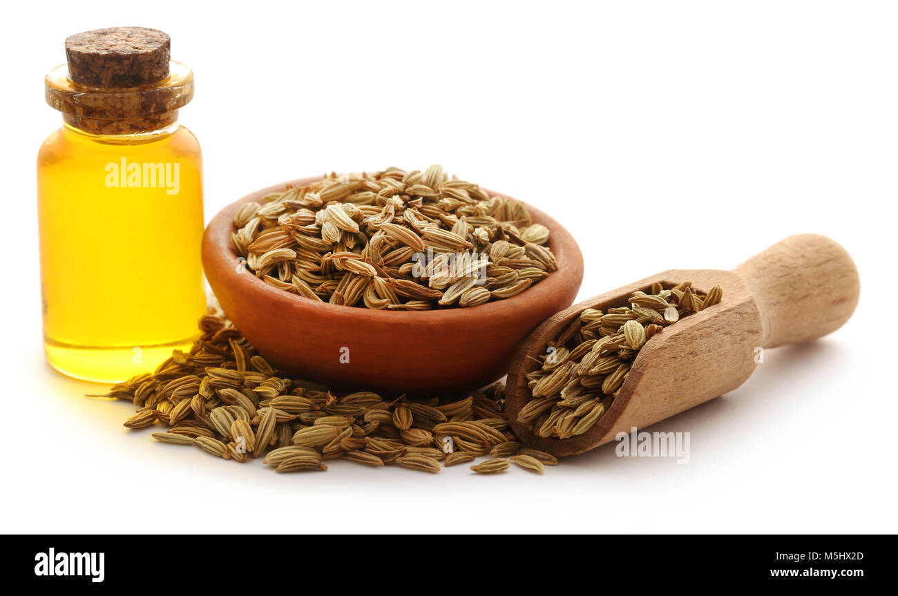 Fennel seeds with essential oil in a bottle over white background Stock Photo