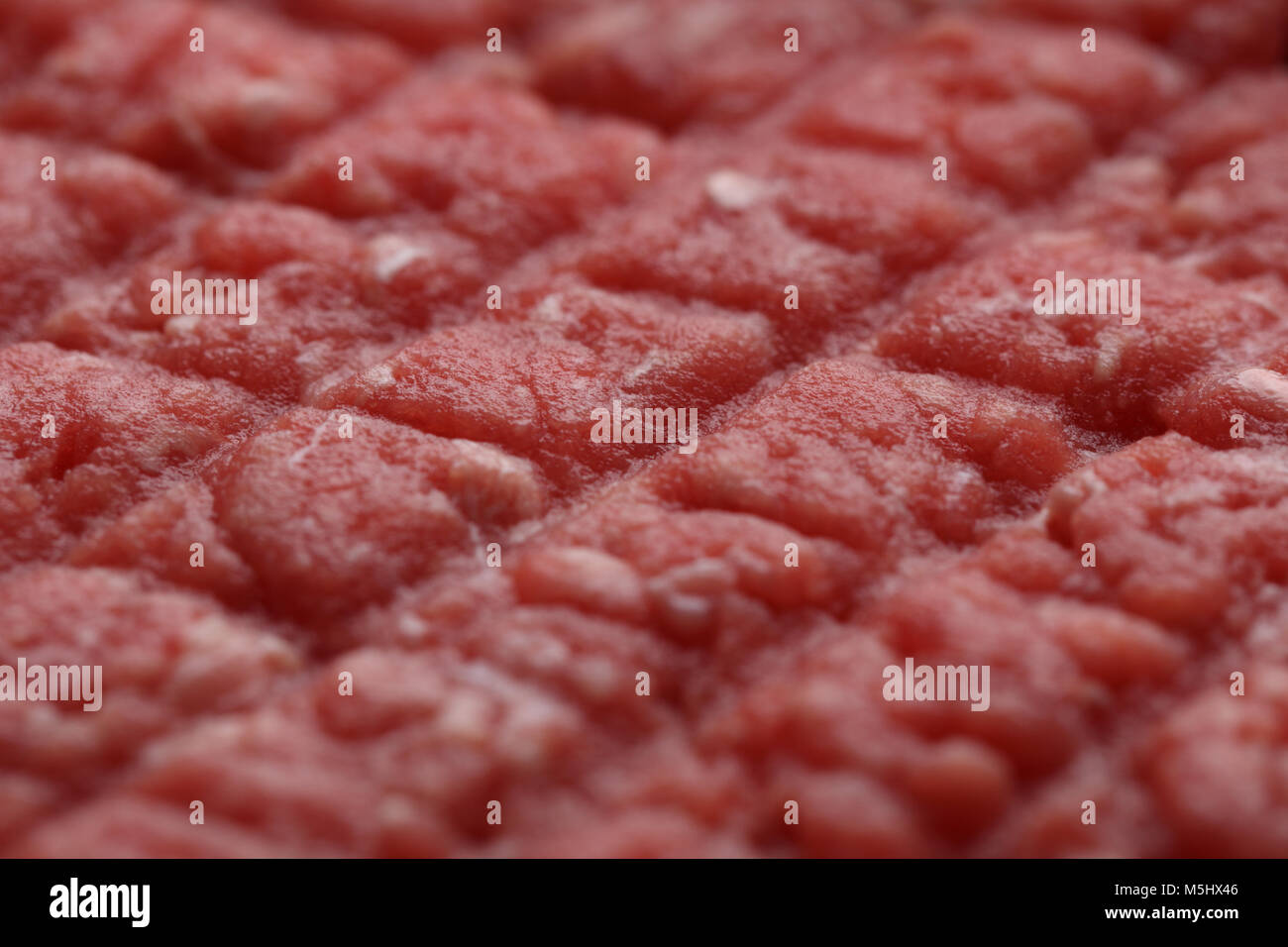 Texture of the surface of raw beef hamburger. Selective focus on the center Stock Photo