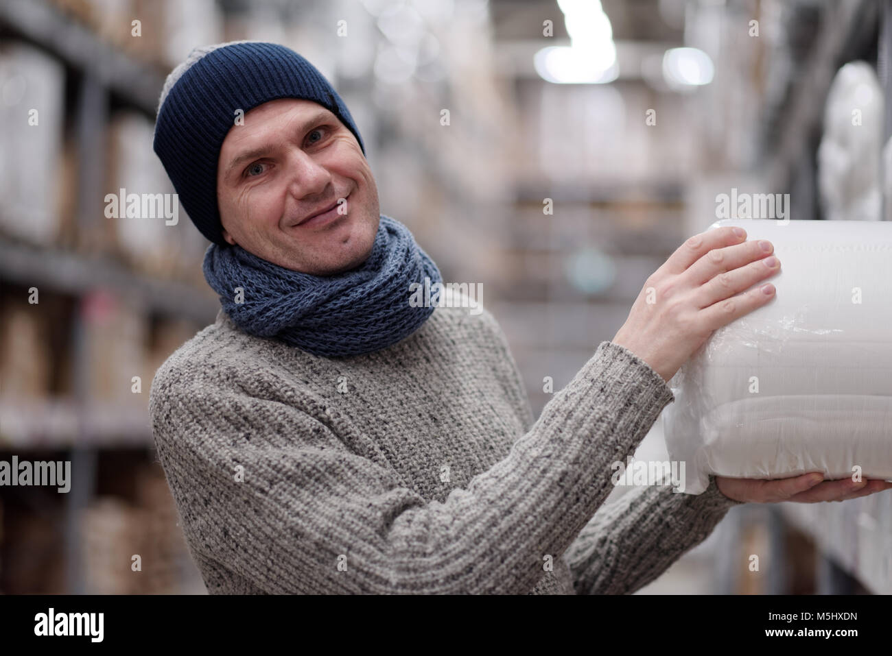 Mature man taking an item in a warehouse of a store Stock Photo