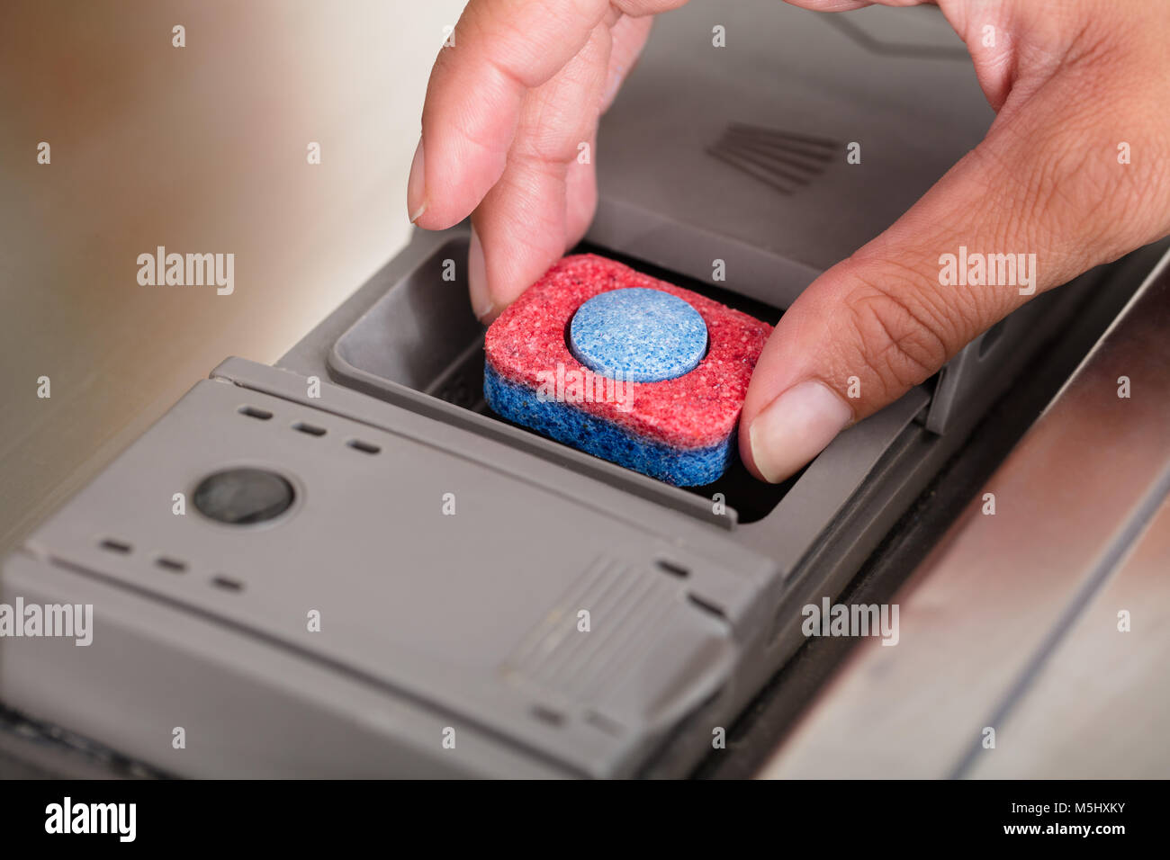 Close-up Of Person Hand Putting Tablet In Dishwasher Machine Stock Photo -  Alamy