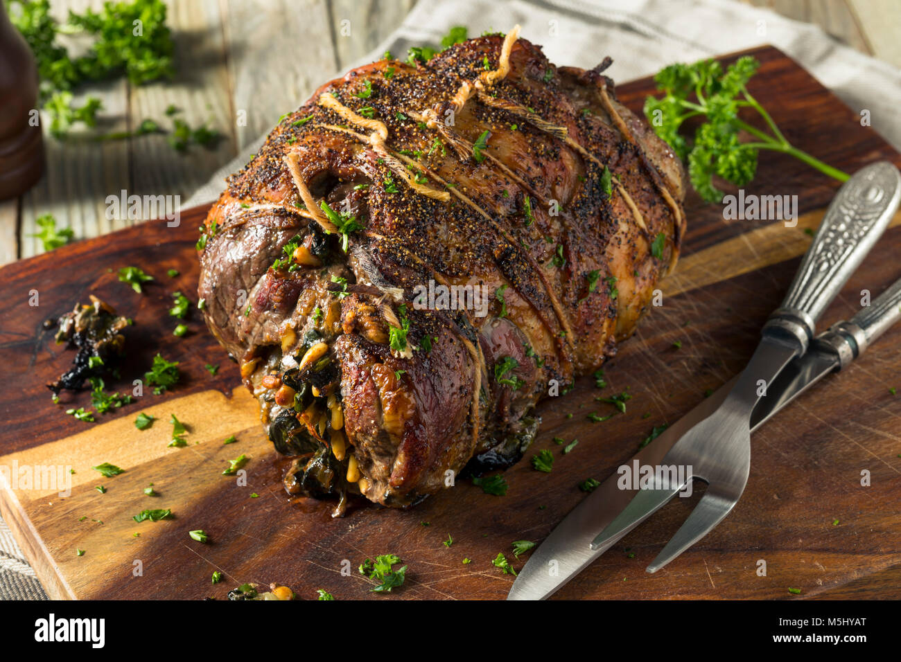 Roasted Stuffed Leg of Lamb with Spinach and Pine Nuts Stock Photo